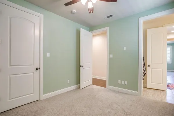 a view of a livingroom with a chandelier fan