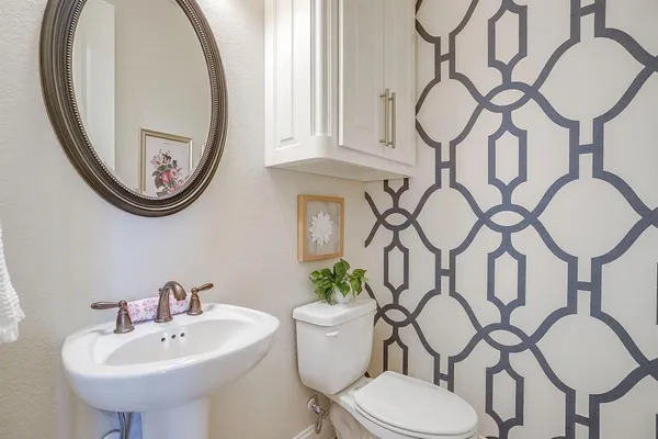 a bathroom with a toilet a sink and a mirror