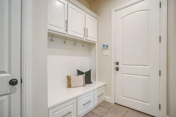 a kitchen with cabinets and a refrigerator