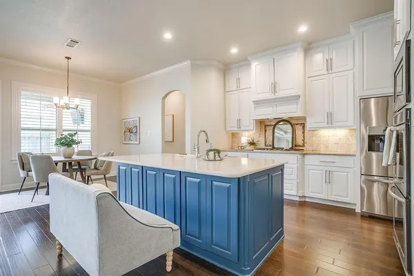 a kitchen with stainless steel appliances granite countertop a sink refrigerator and cabinets