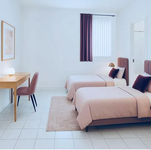 a bedroom with a bed a chair and next to a window