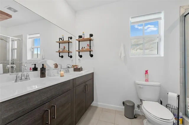 a bathroom with a sink mirror vanity and toilet