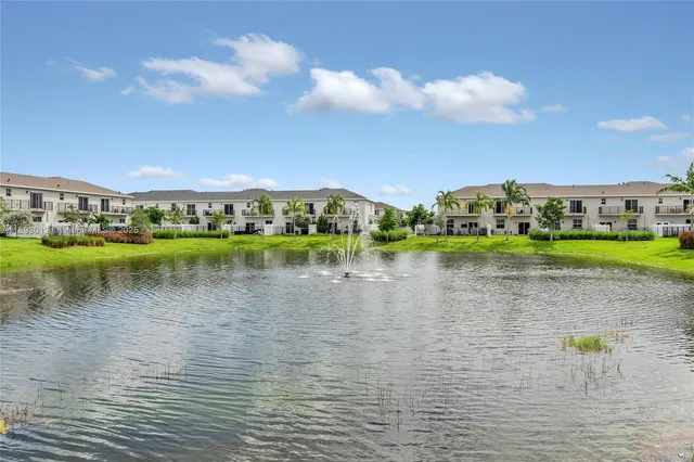 a view of a lake with houses in the back
