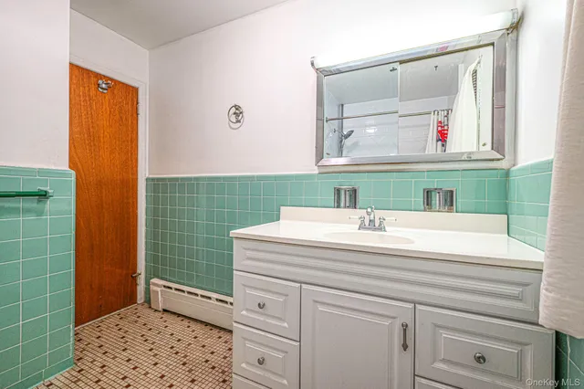 a bathroom with a sink a vanity and a mirror