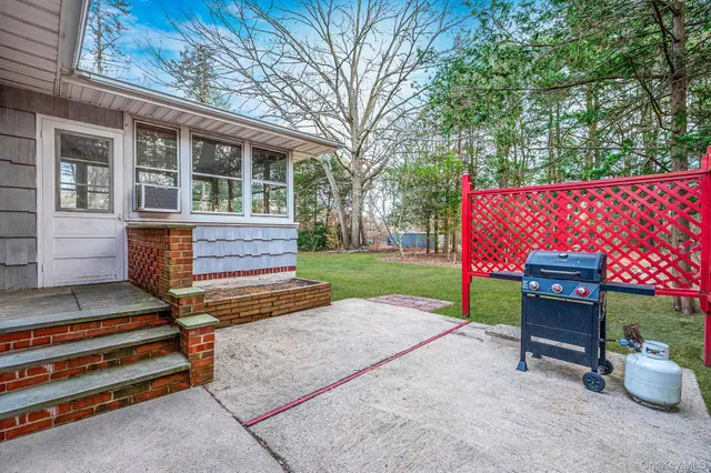 a view of a deck with chairs and a yard