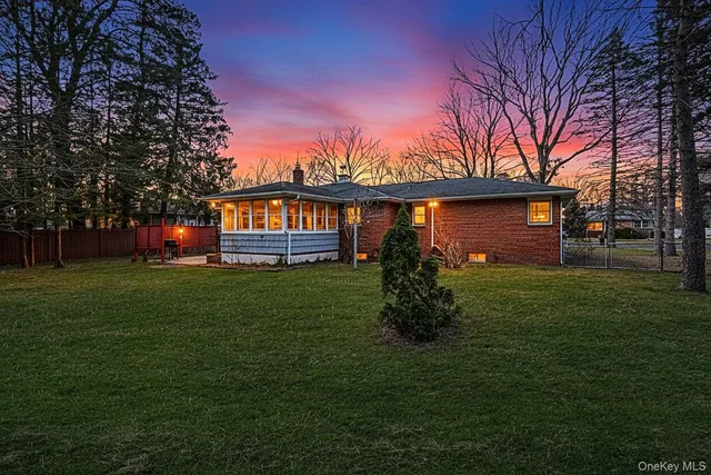 a front view of a house with a garden