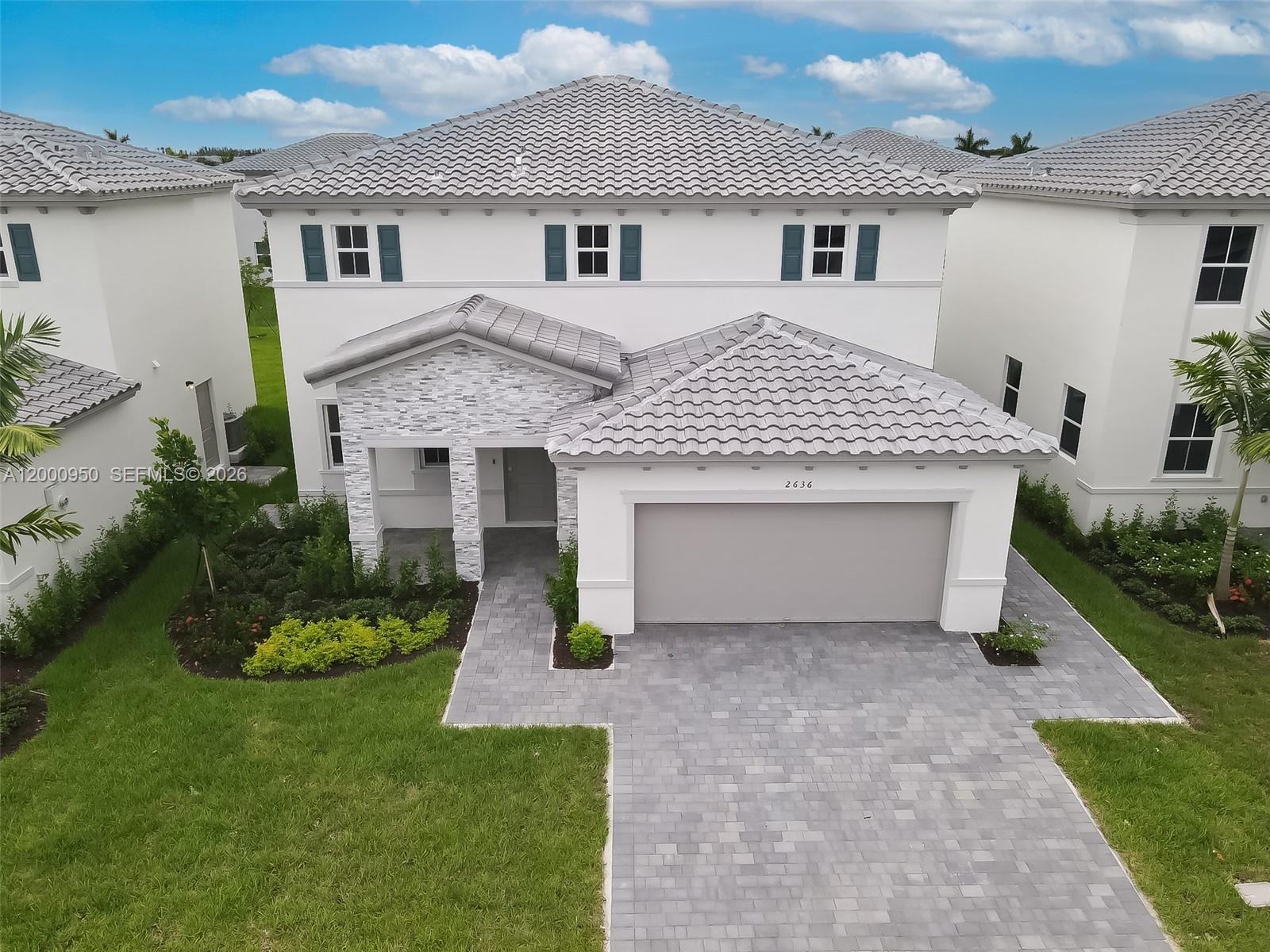 2636 Southeast 8th Court Homestead, FL 33035 - Photo 1 of 34 a front view of a house with a garden and plants