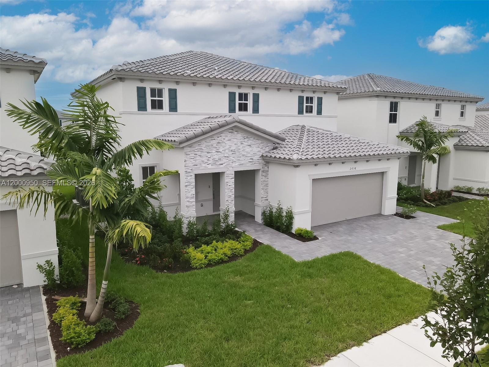 2636 Southeast 8th Court Homestead, FL 33035 - Photo 2 of 34 a front view of a house with a garden and plants