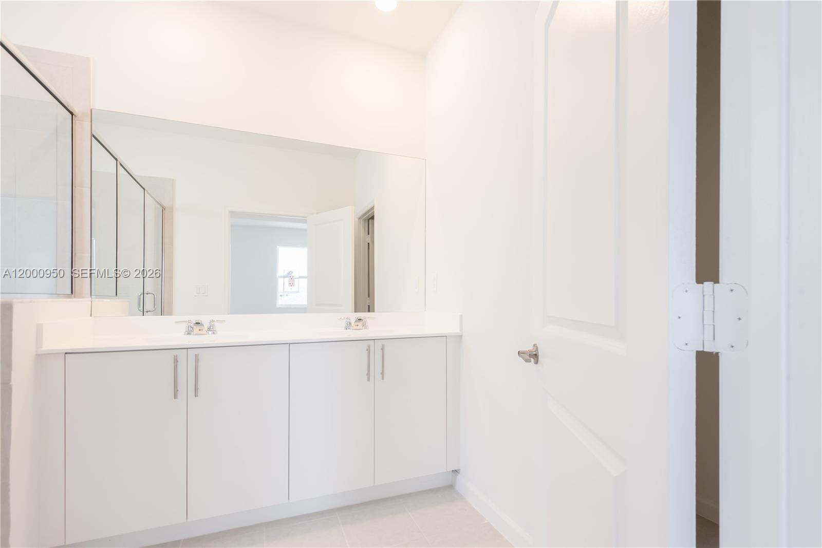 2636 Southeast 8th Court Homestead, FL 33035 - Photo 22 of 34 a bathroom with a sink and a mirror