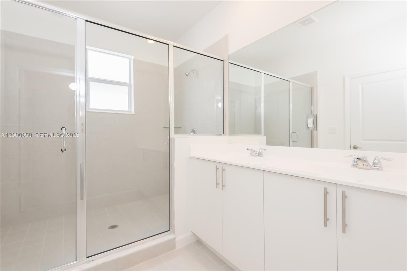 2636 Southeast 8th Court Homestead, FL 33035 - Photo 23 of 34 a bathroom with a shower sink and mirror