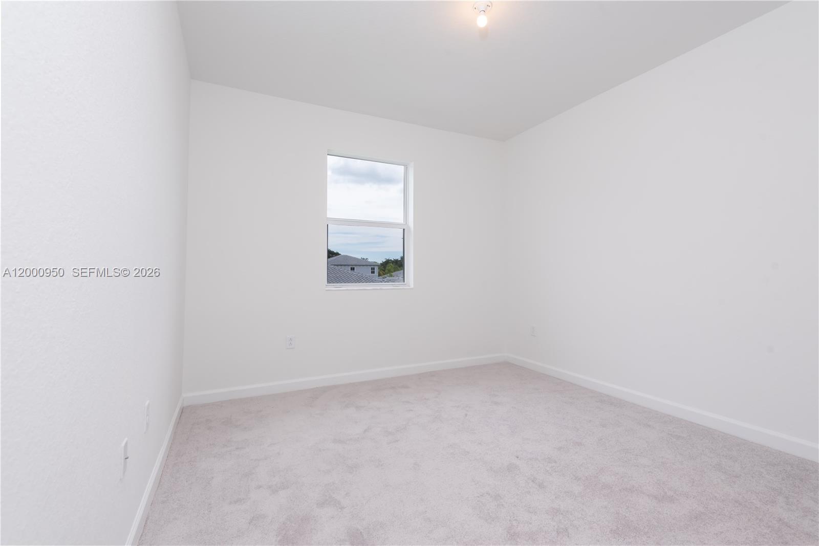 2636 Southeast 8th Court Homestead, FL 33035 - Photo 29 of 34 an empty room with a window