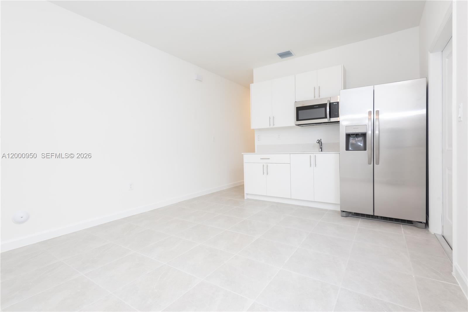 2636 Southeast 8th Court Homestead, FL 33035 - Photo 5 of 34 a view of kitchen with white cabinets