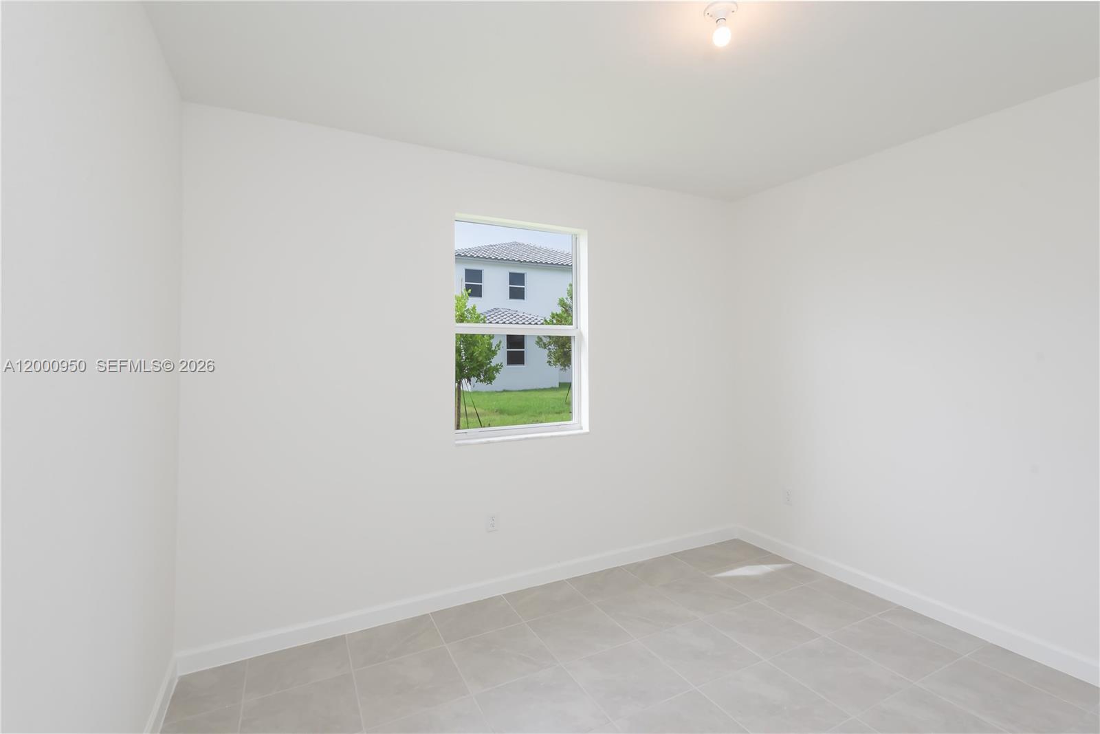 2636 Southeast 8th Court Homestead, FL 33035 - Photo 8 of 34 a view of an empty room with a window