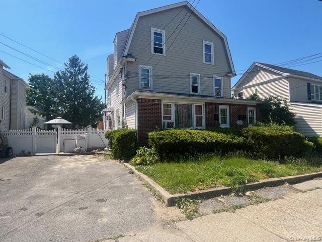 45 James Street Inwood, NY 11096 - Photo 4 of 11 a front view of a house with a garden and plants