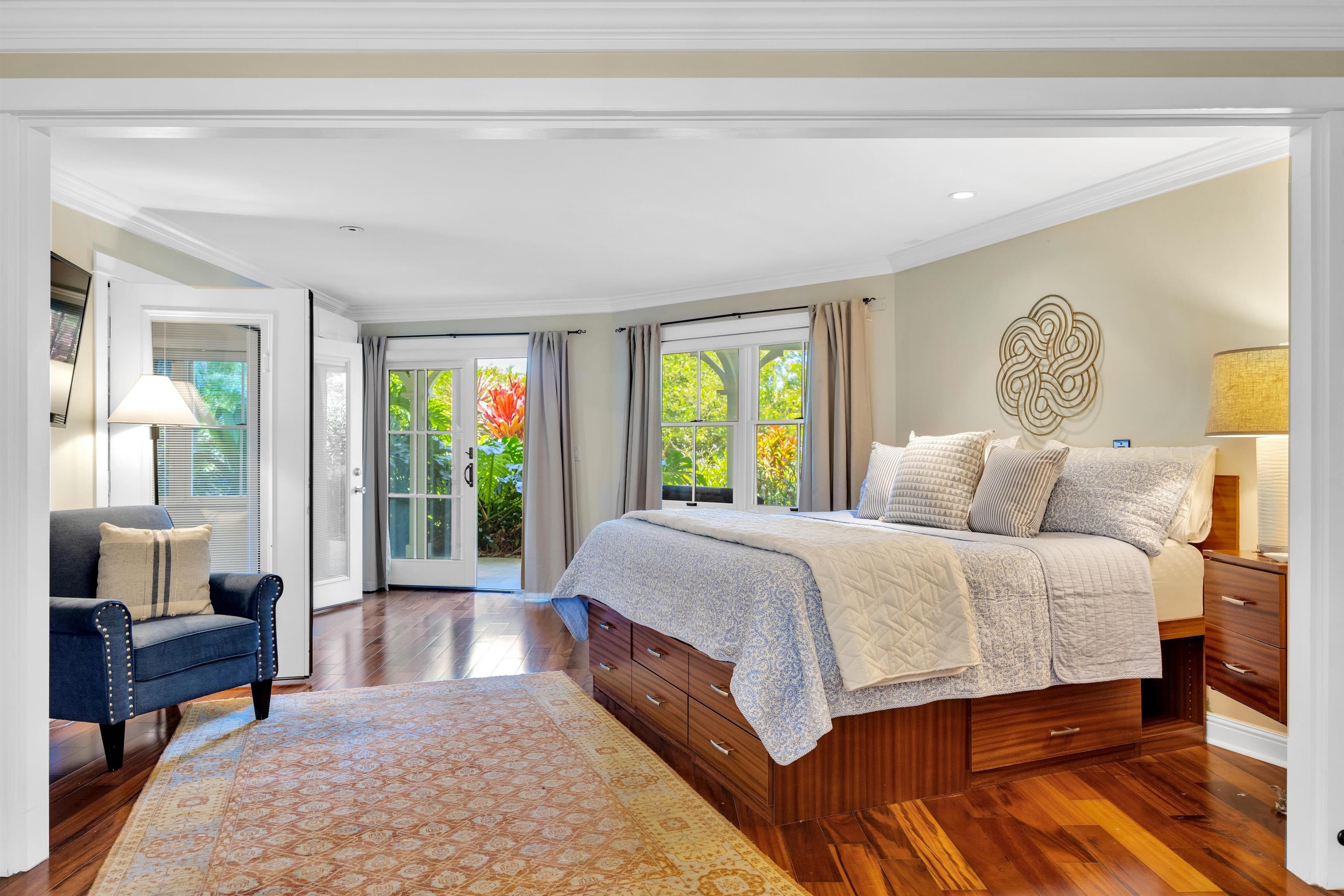 65 North Holokai Road Haiku, HI 96708 - Photo 11 of 50 a spacious bedroom with a large bed and a window