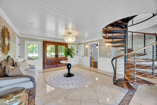 a view of a livingroom with furniture and floor to ceiling window