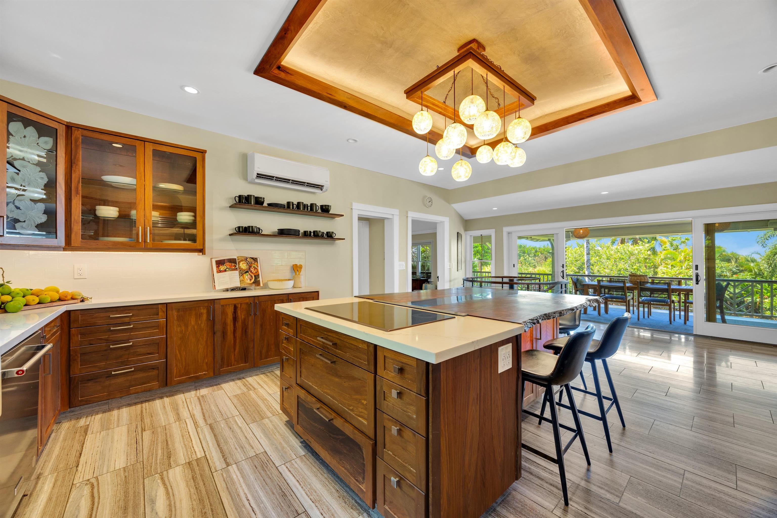 65 North Holokai Road Haiku, HI 96708 - Photo 15 of 50 a kitchen with a stove a sink a dining table and chairs with wooden floor