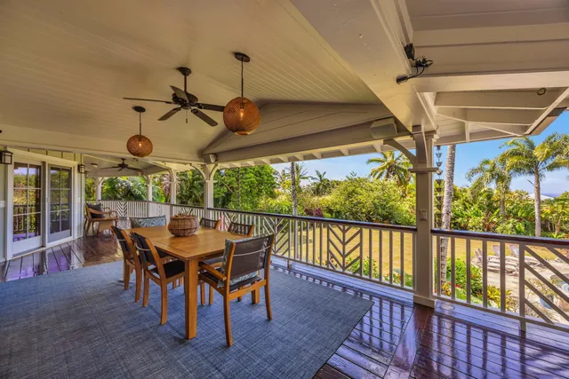 a view of a porch with furniture and a yard