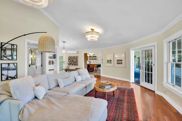 a living room with furniture and a chandelier
