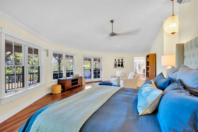 a bedroom with furniture and a large window