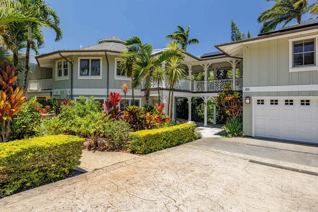 a front view of a house with a garden