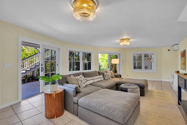 a living room with furniture a window and a flat screen tv