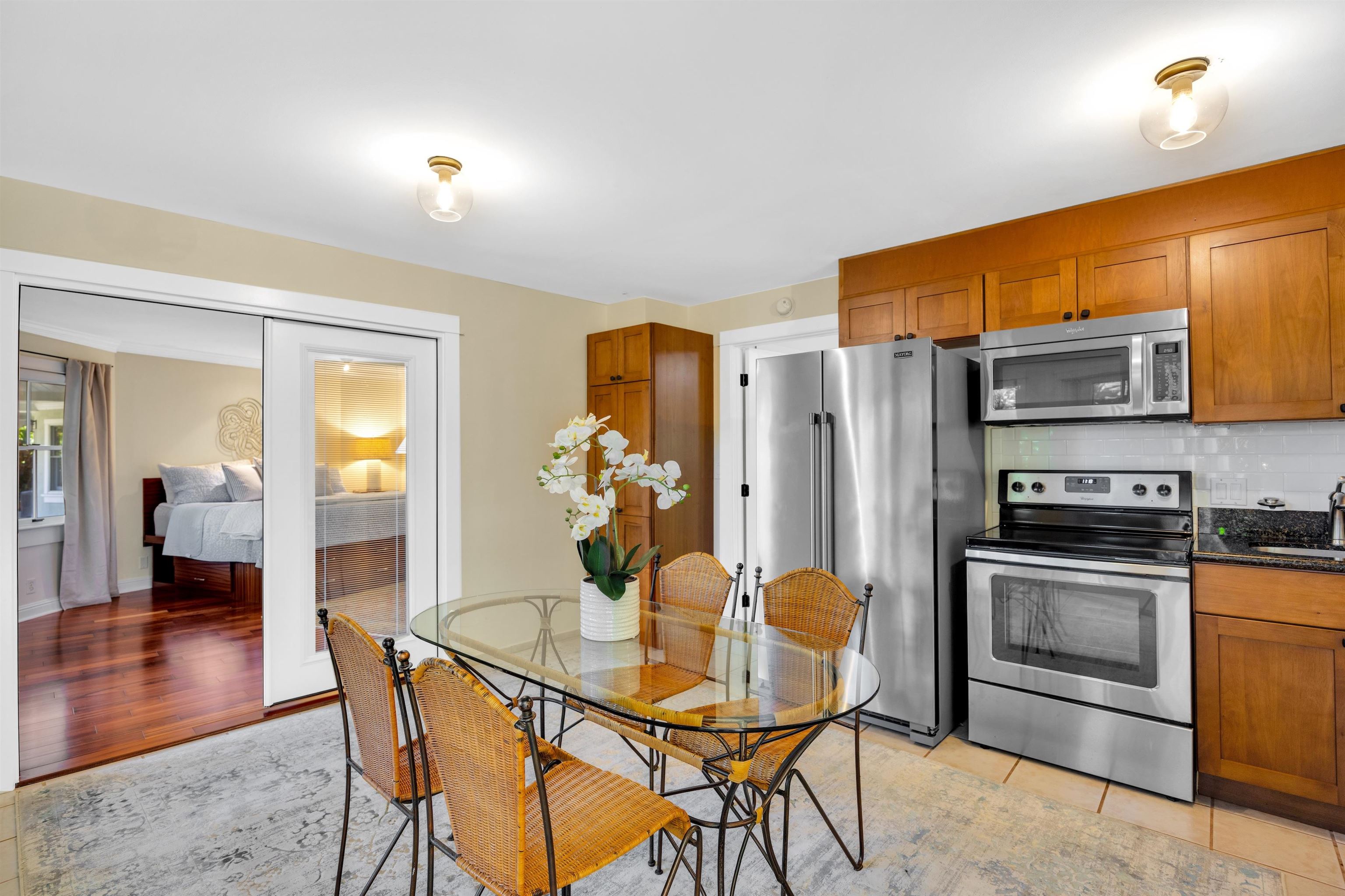 65 North Holokai Road Haiku, HI 96708 - Photo 34 of 50 a kitchen with stainless steel appliances a dining table chairs and granite counter tops