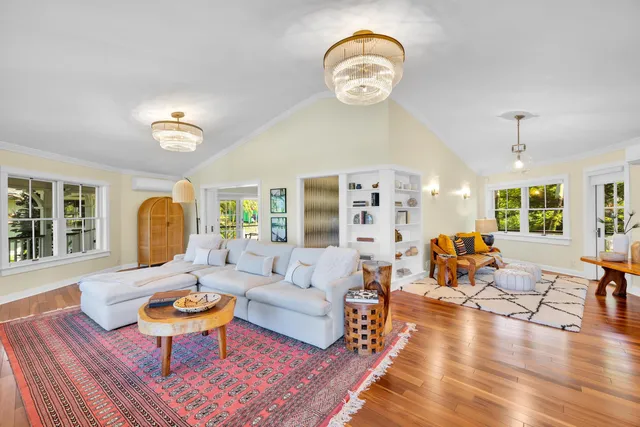 a living room with furniture fireplace and wooden floor