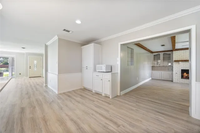 a view of a kitchen with wooden floor and a refrigerator