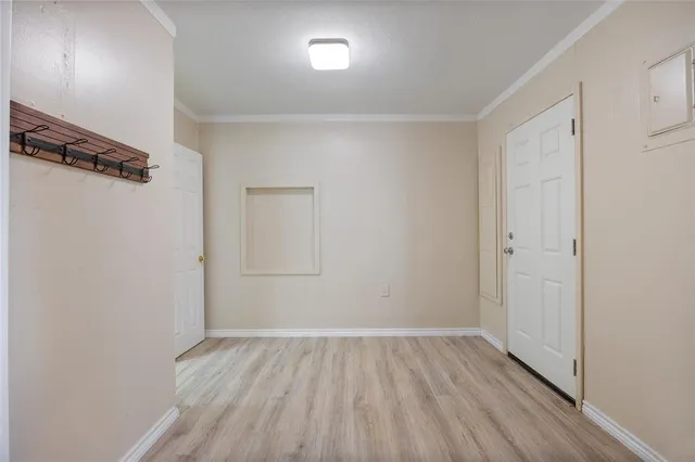 a view of a room with wooden floor