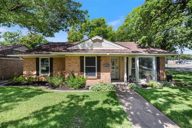 a front view of a house with garden and porch