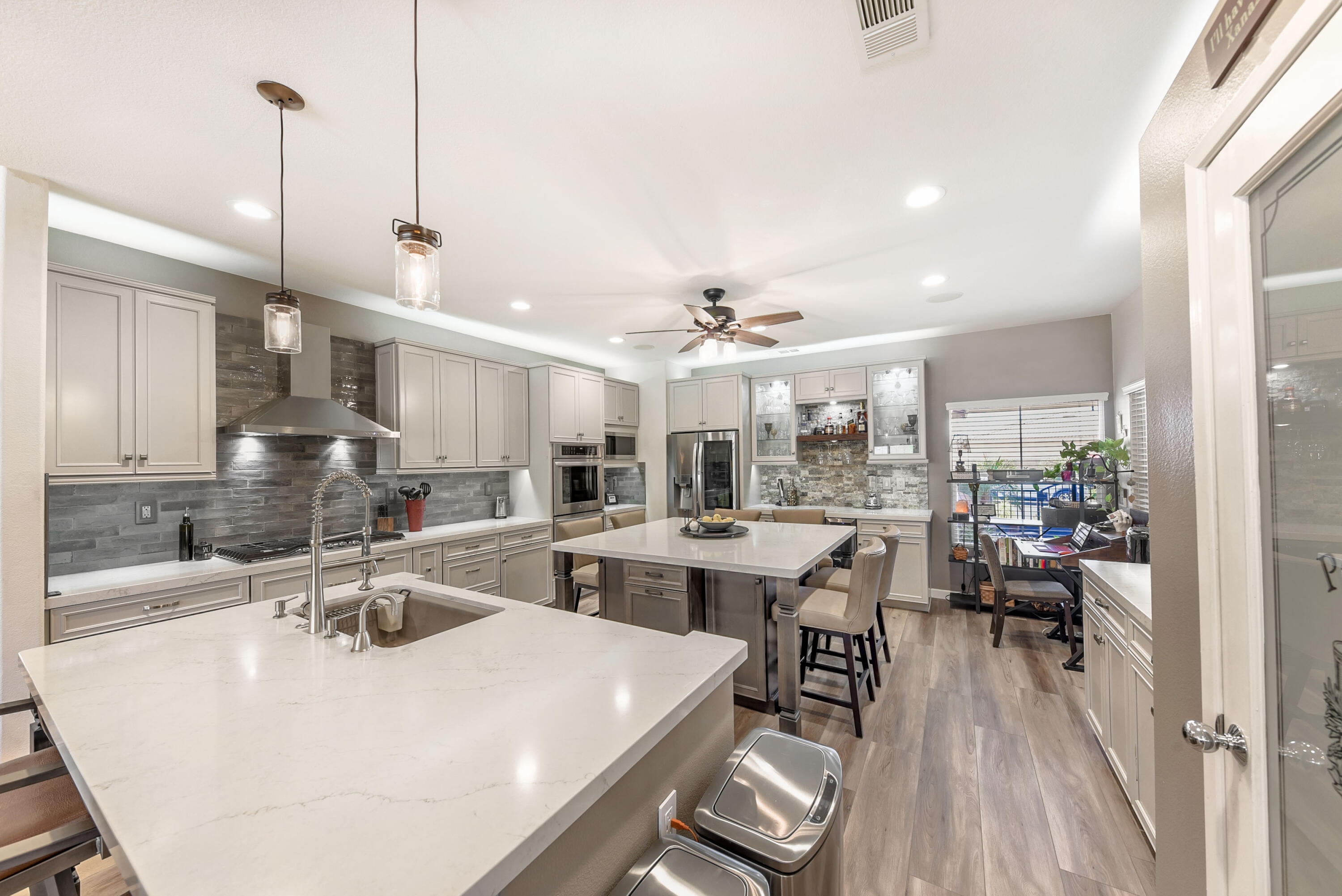 83164 Prairie Dunes Way Indio, CA 92203 - Photo 1 of 60 a kitchen with sink stove and white cabinets with wooden floor