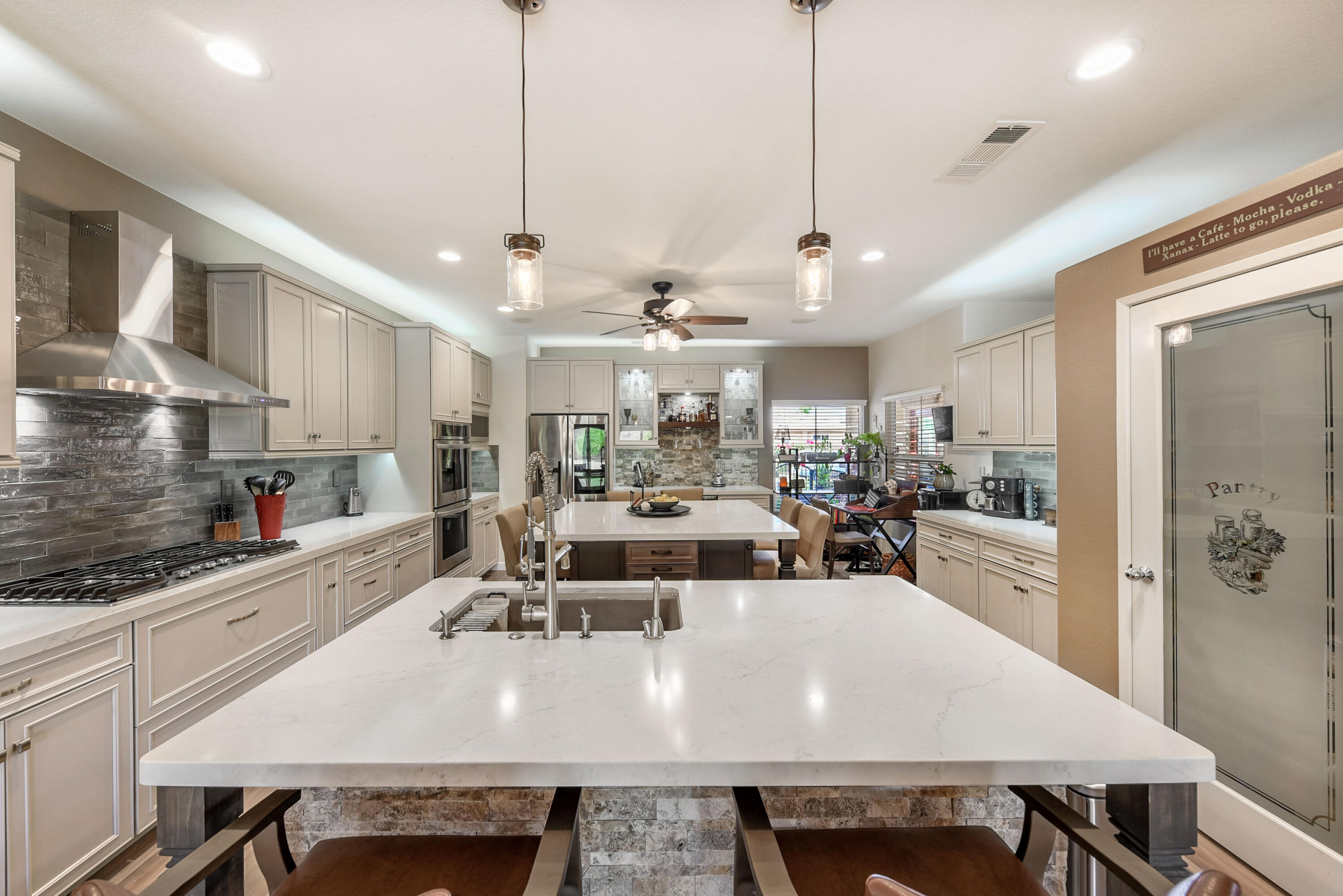 83164 Prairie Dunes Way Indio, CA 92203 - Photo 11 of 60 a large kitchen with a table and chairs