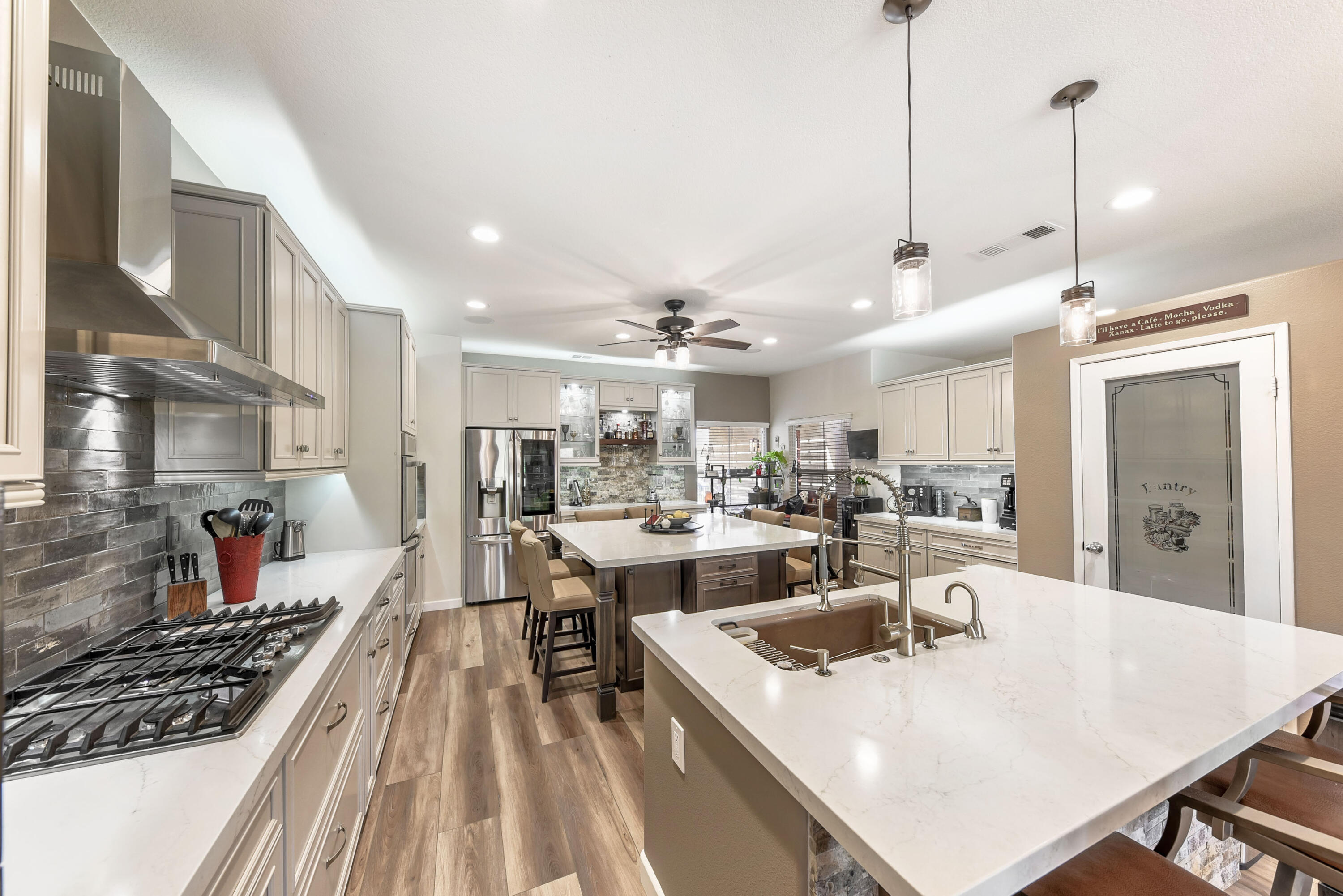 83164 Prairie Dunes Way Indio, CA 92203 - Photo 12 of 60 a view of a dining room and livingroom with furniture wooden floor a chandelier