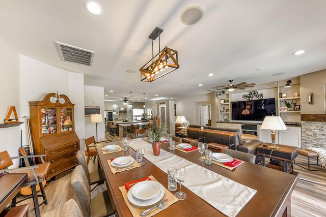 a living room with furniture kitchen view and a large window