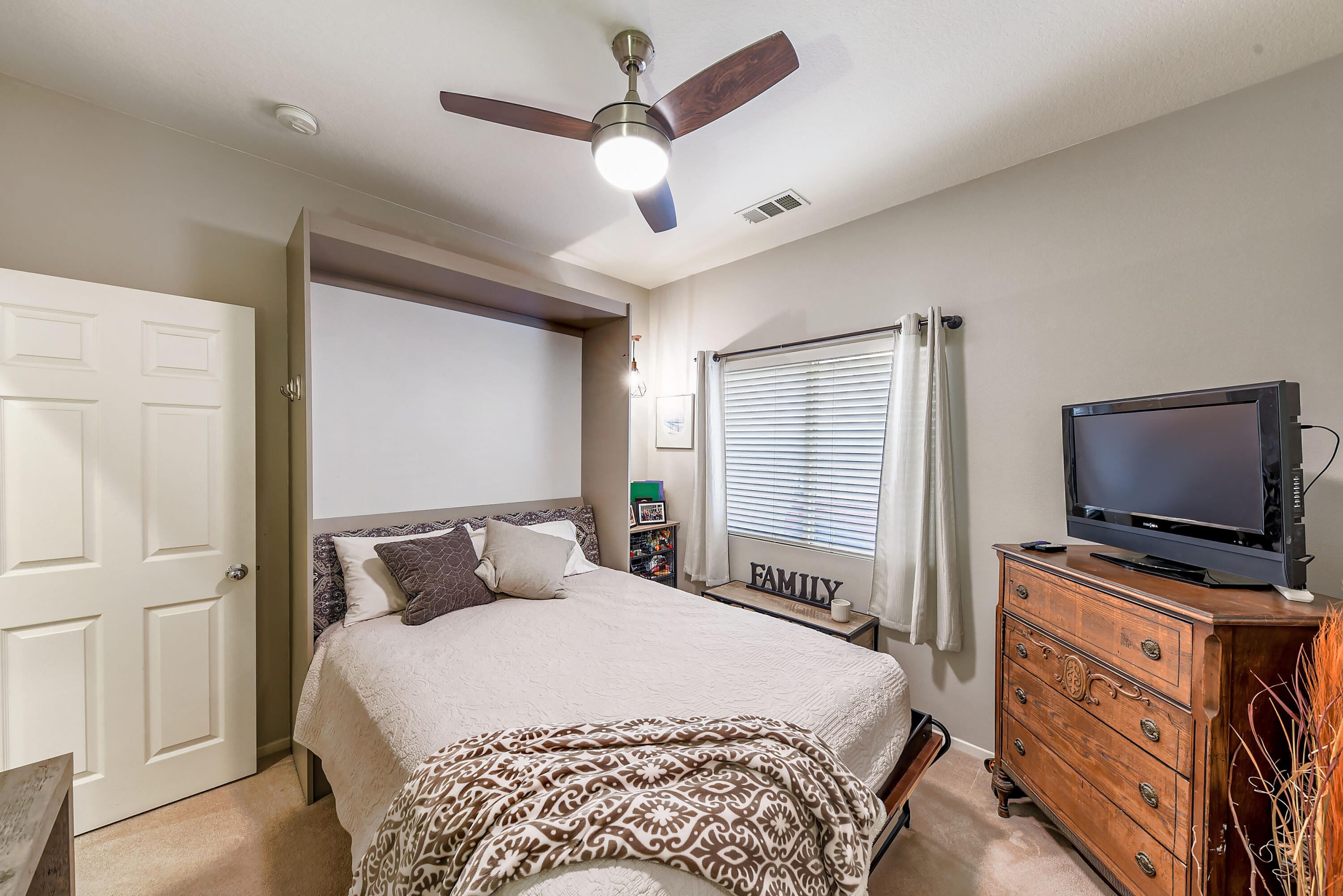 83164 Prairie Dunes Way Indio, CA 92203 - Photo 21 of 60 a bedroom with a bed and a flat tv screen on dresser