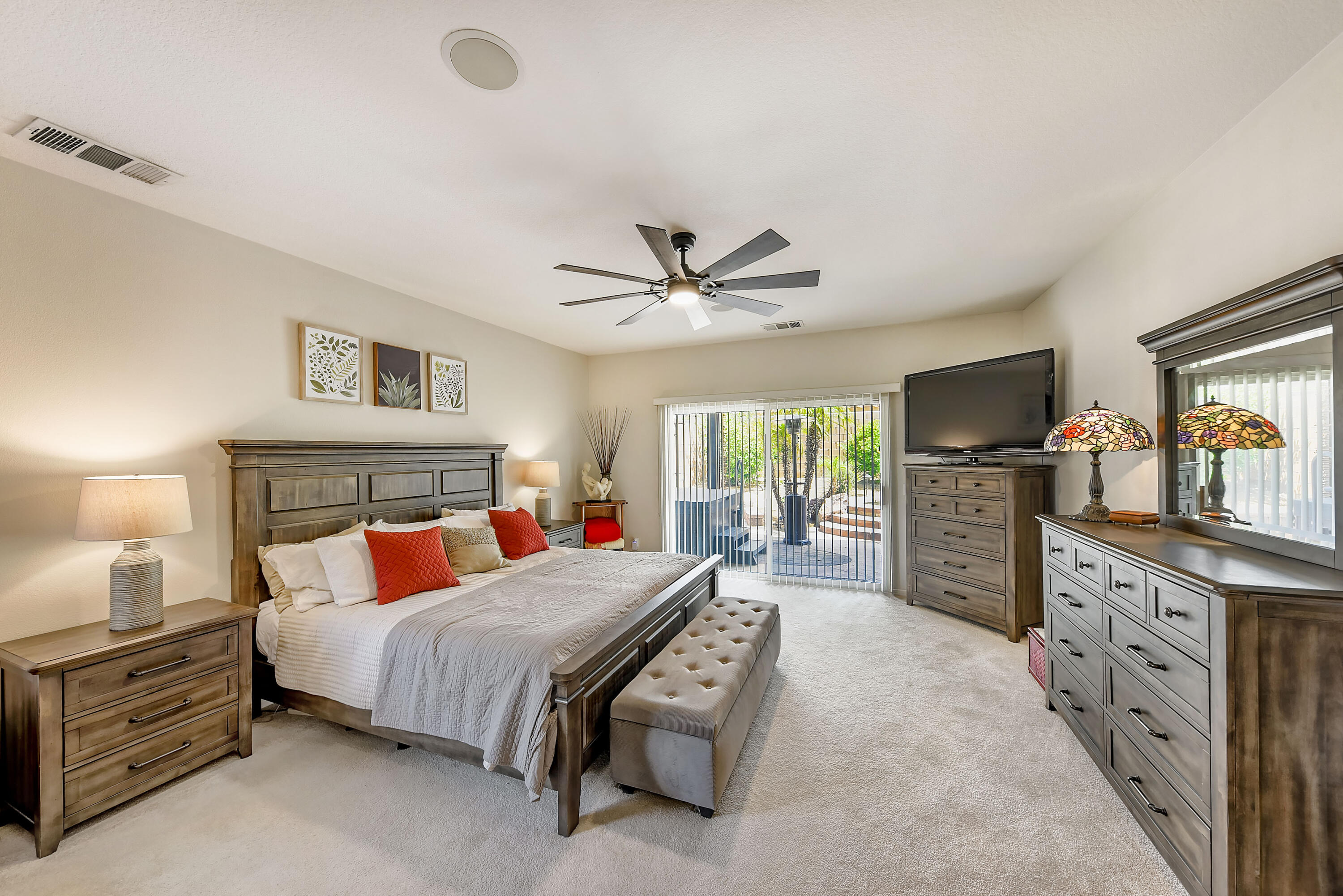 83164 Prairie Dunes Way Indio, CA 92203 - Photo 23 of 60 a bedroom with a bed a dresser and flat screen tv