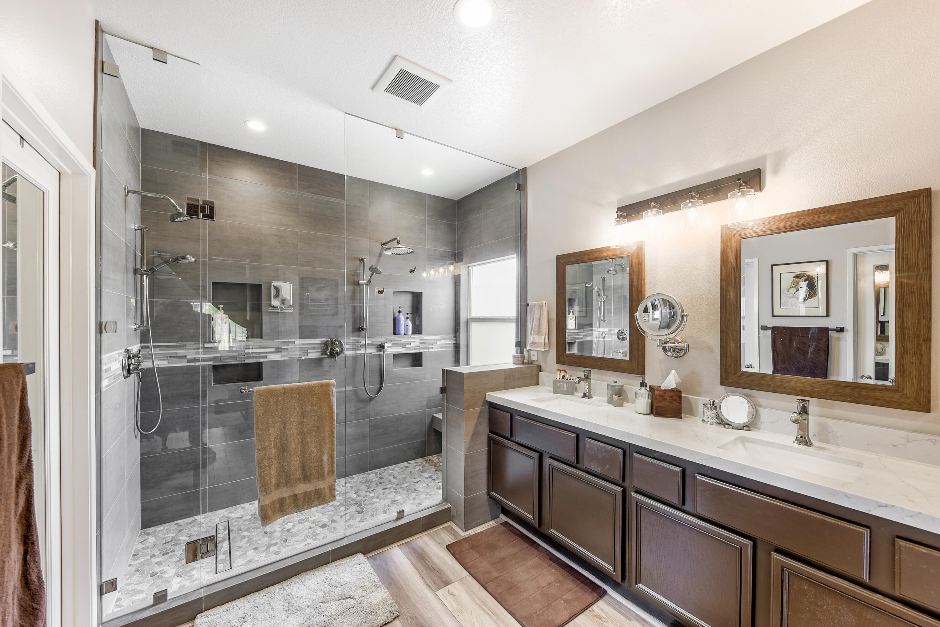 83164 Prairie Dunes Way Indio, CA 92203 - Photo 25 of 60 a bathroom with a double vanity sink mirror and shower