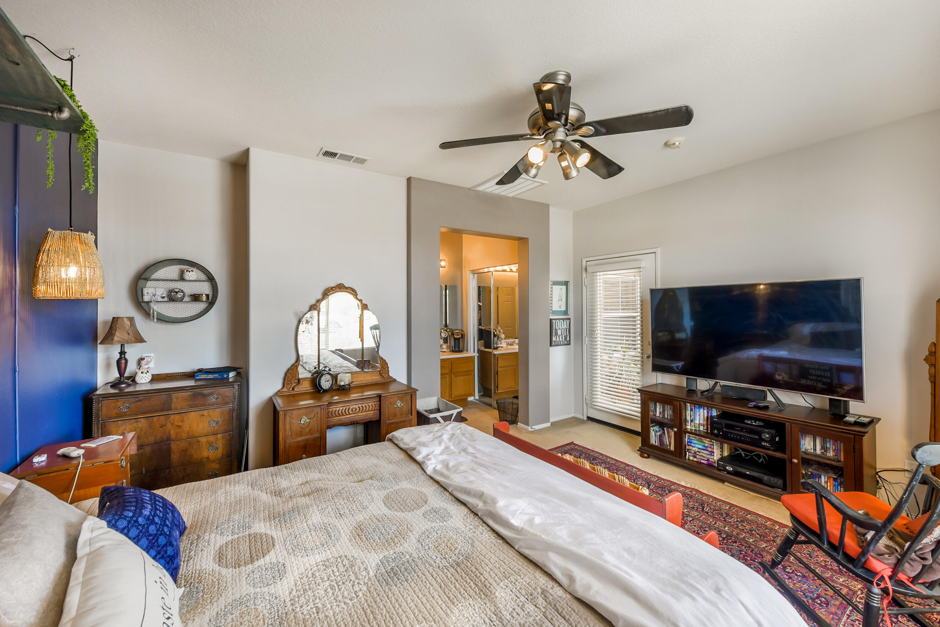 83164 Prairie Dunes Way Indio, CA 92203 - Photo 31 of 60 a bedroom with a bed and a flat tv screen on wall