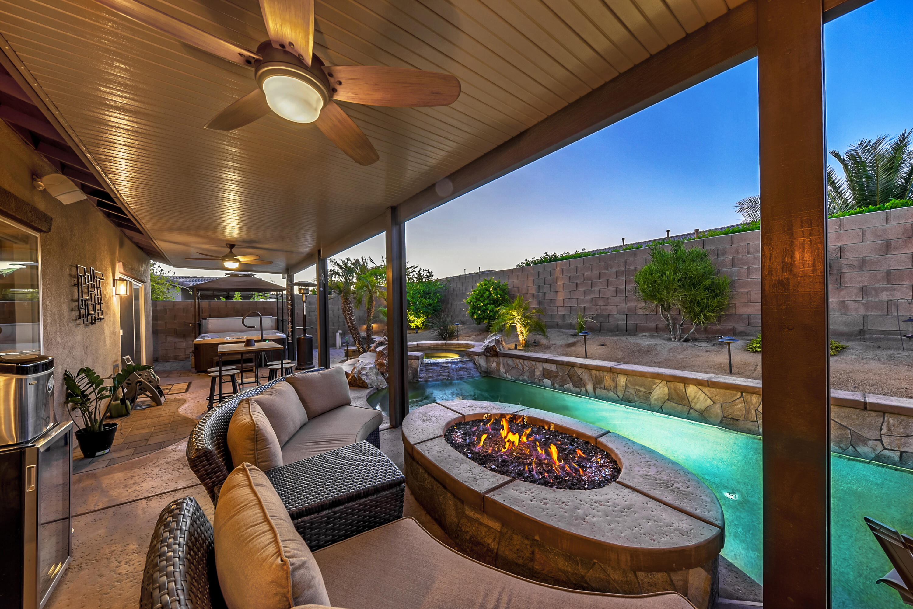 83164 Prairie Dunes Way Indio, CA 92203 - Photo 38 of 60 a living room with patio furniture and a fireplace