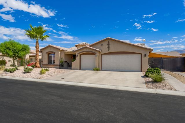a front view of a house with a yard and a garage
