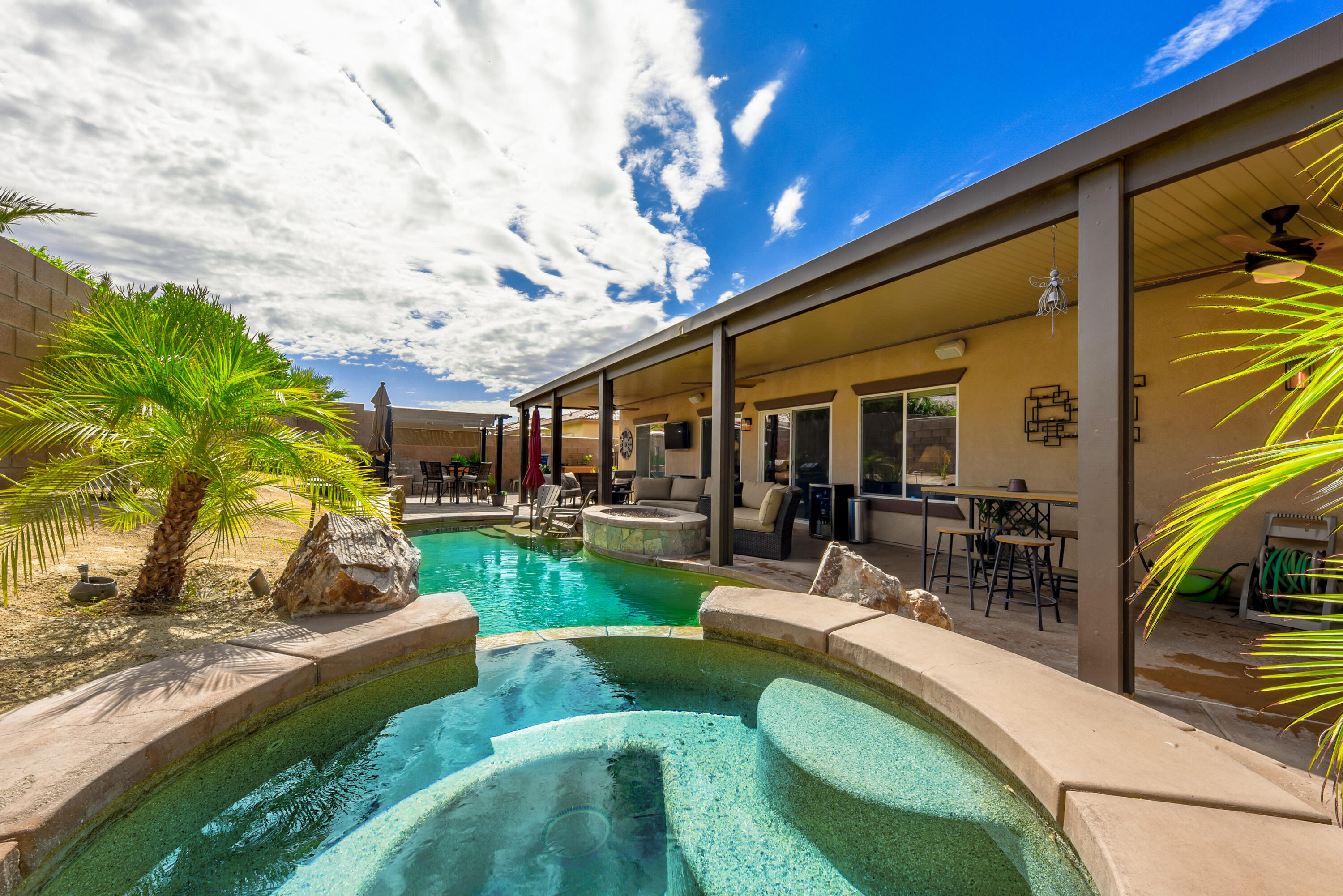 83164 Prairie Dunes Way Indio, CA 92203 - Photo 41 of 60 a view of a patio with couches chairs and a big yard
