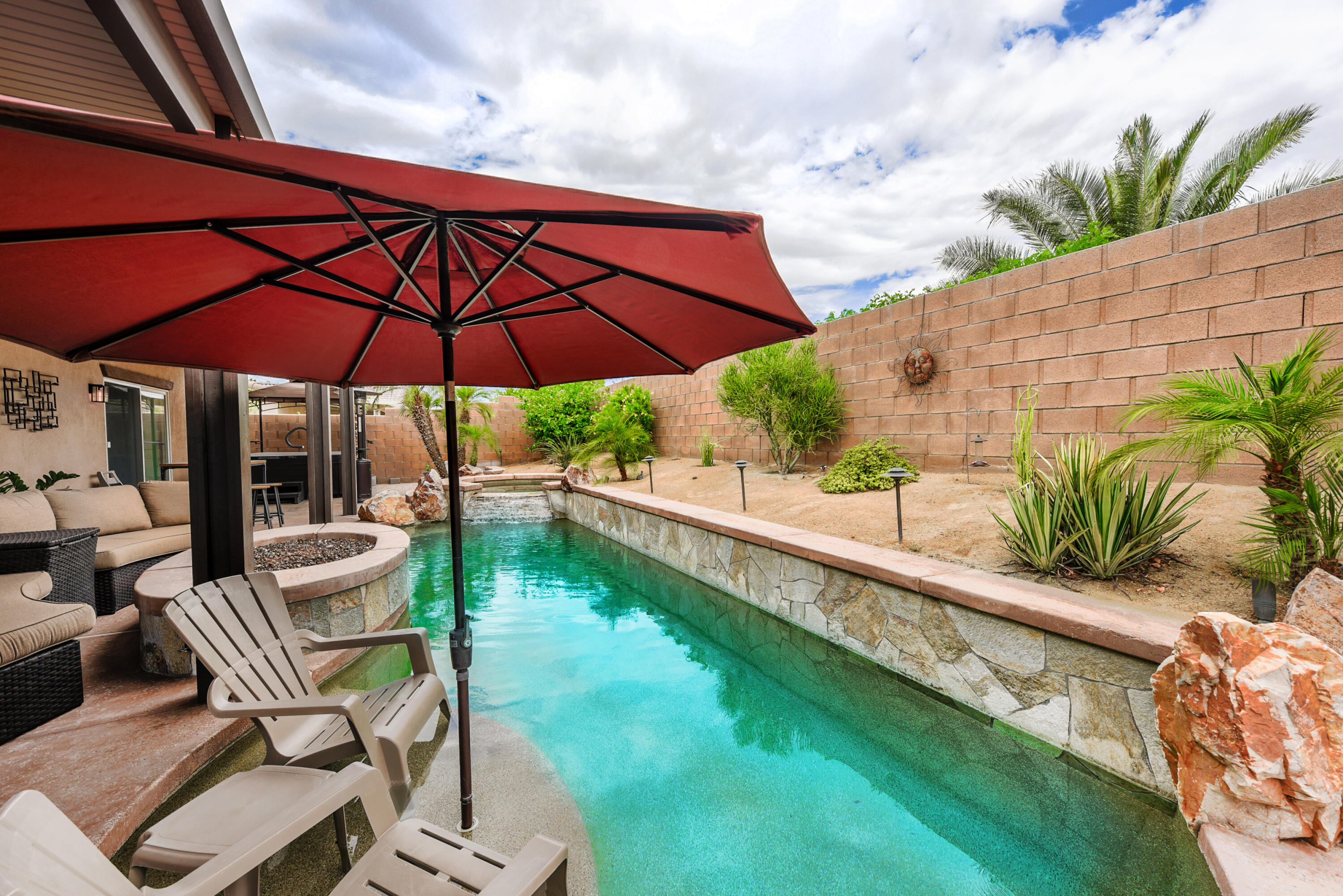 83164 Prairie Dunes Way Indio, CA 92203 - Photo 42 of 60 a view of a patio with chairs under an umbrella