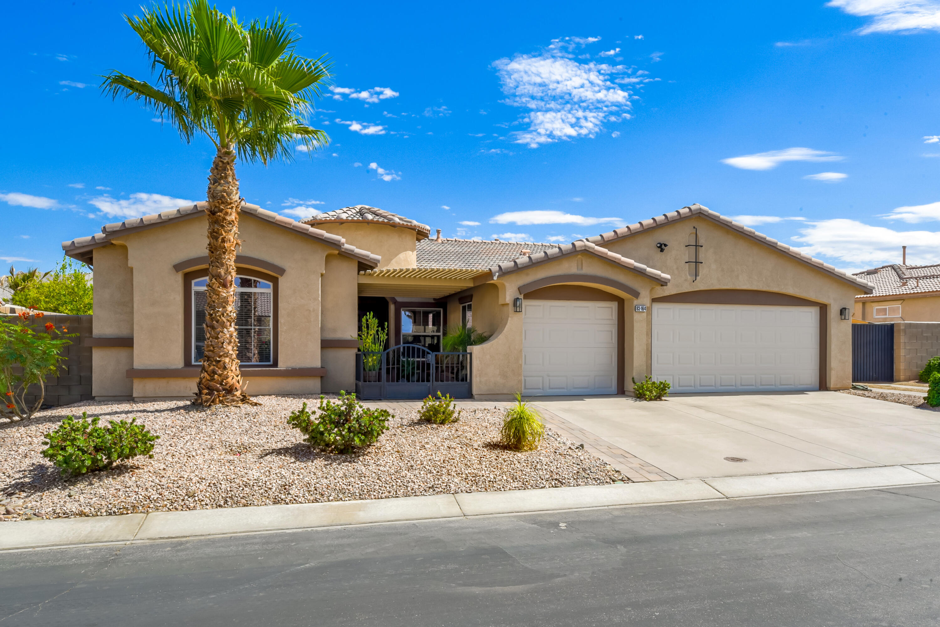 83164 Prairie Dunes Way Indio, CA 92203 - Photo 5 of 60 a front view of a house with a yard and garage