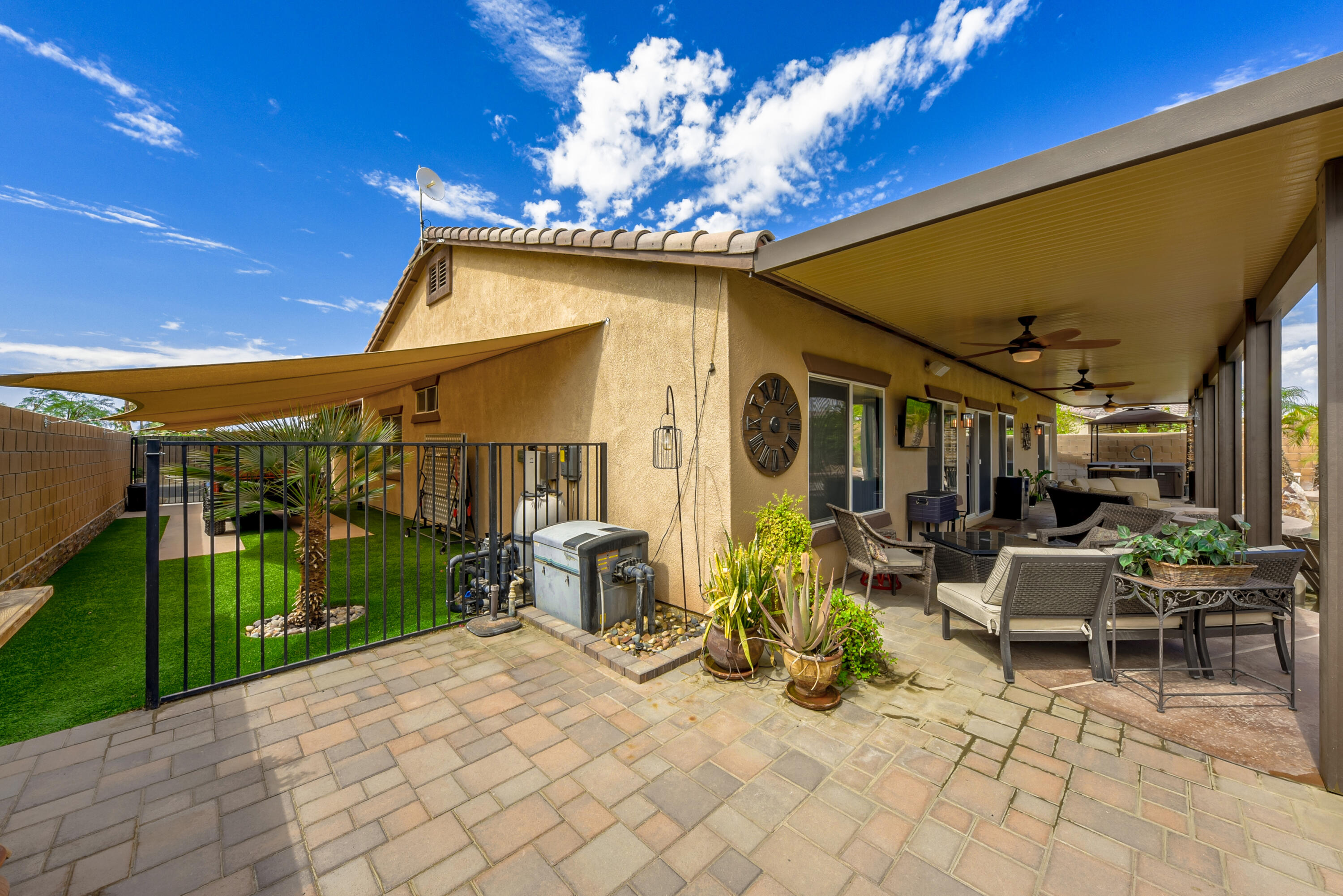 83164 Prairie Dunes Way Indio, CA 92203 - Photo 52 of 60 a view of a patio with table and chairs potted plants with wooden fence