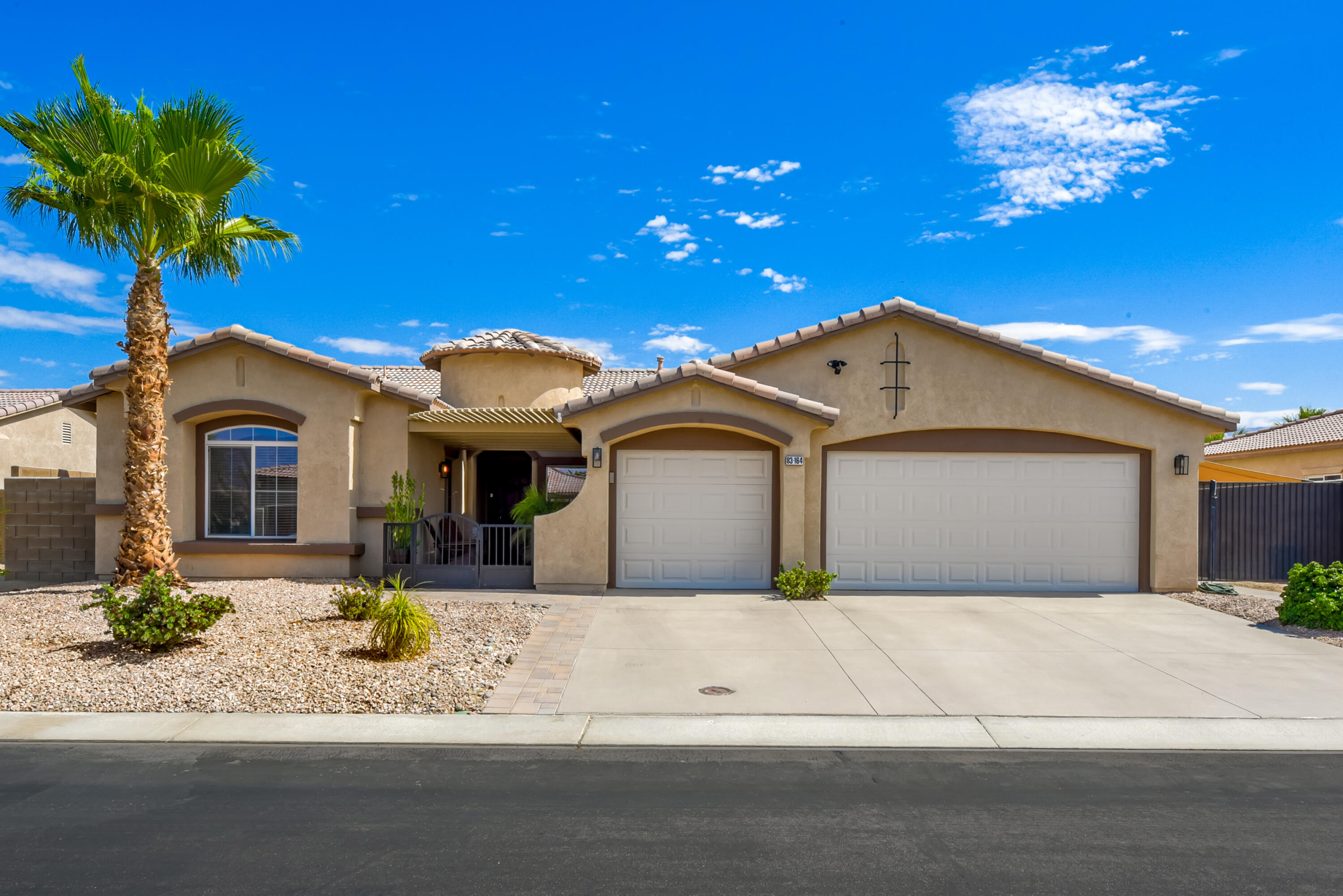 83164 Prairie Dunes Way Indio, CA 92203 - Photo 56 of 60 a front view of a house with a yard and garage