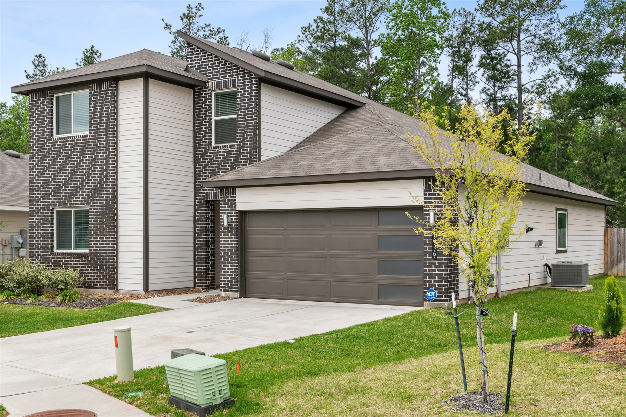 14379 Sweet Mdw Trail Conroe, TX 77384 - Photo 27 of 33 a front view of a house with a yard and garage