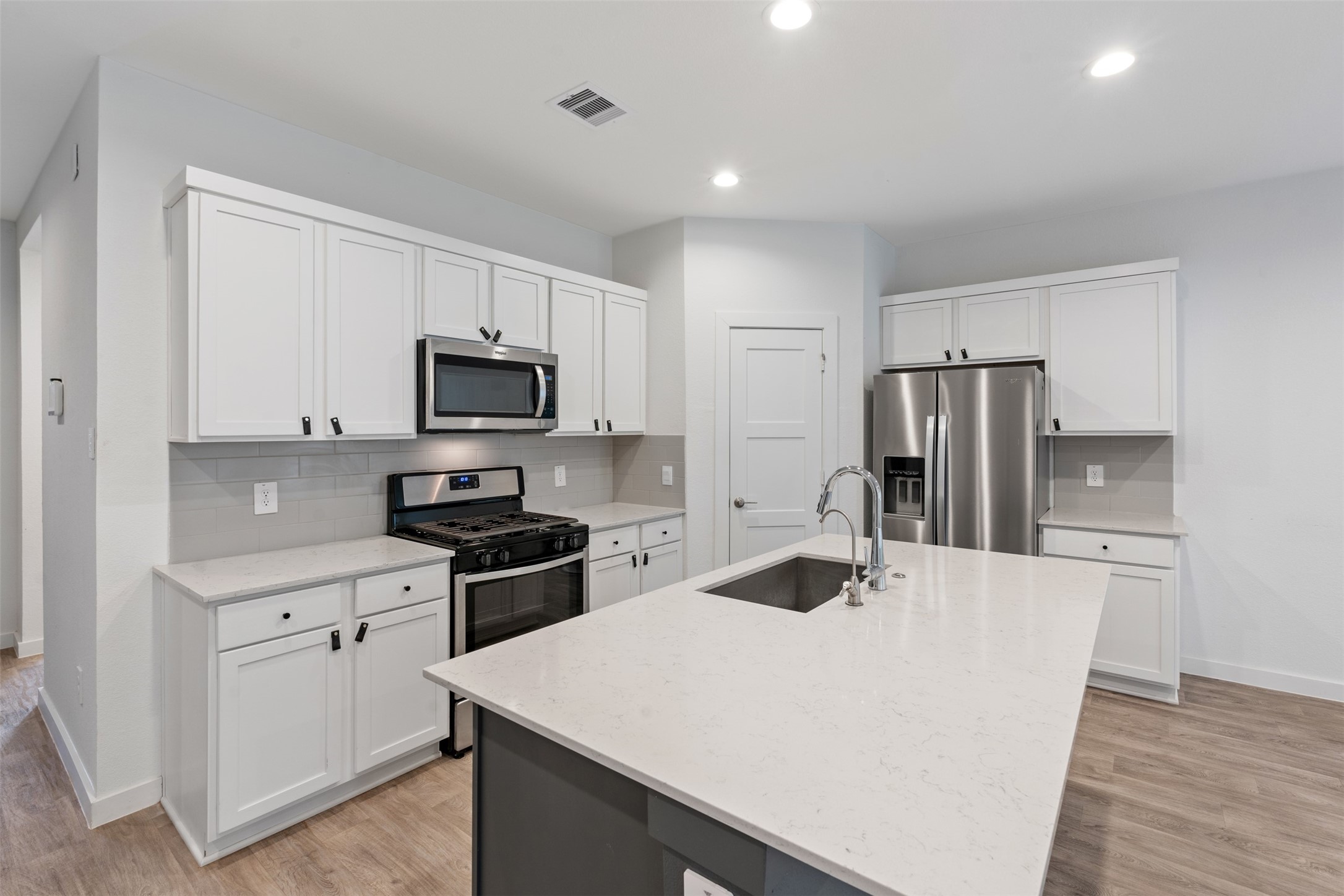 14379 Sweet Mdw Trail Conroe, TX 77384 - Photo 3 of 33 a kitchen with kitchen island a counter top space stainless steel appliances and cabinets