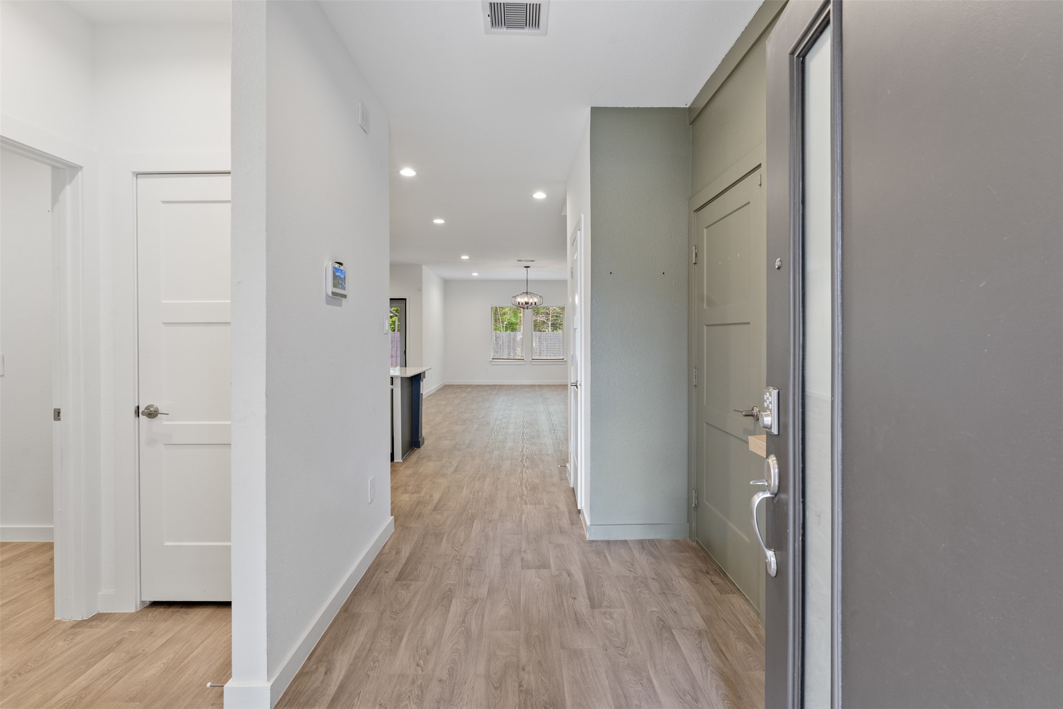 14379 Sweet Mdw Trail Conroe, TX 77384 - Photo 9 of 33 a view of a hallway with wooden floor