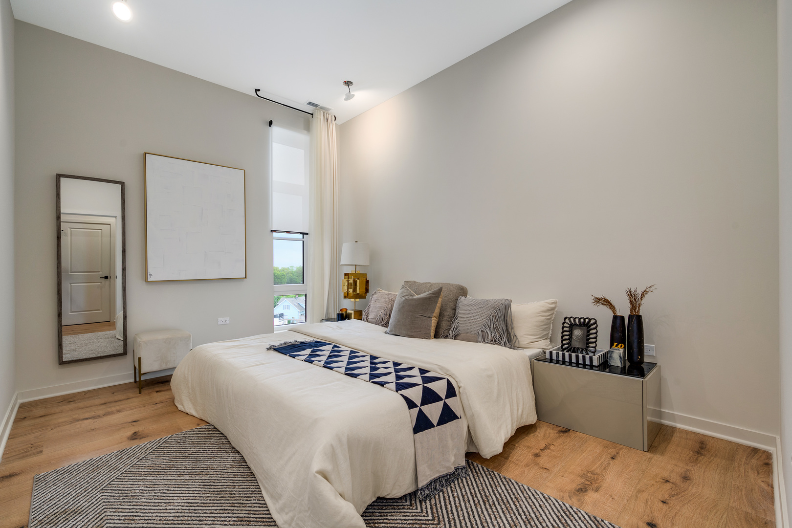 11 West Prospect Avenue, Unit 217 Mount Prospect, IL 60056 - Photo 11 of 66 a bedroom with a bed and a lamp